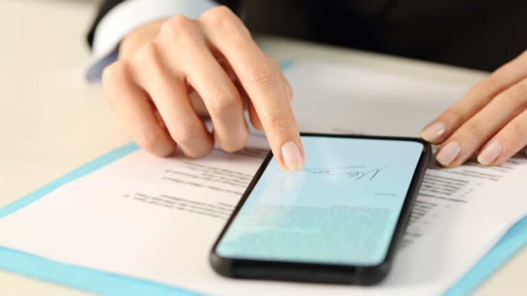 person signing a document on their smartphone
