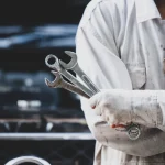 car repairman wearing white uniform standing holding wrench that is essential tool mechanic 1150 16582