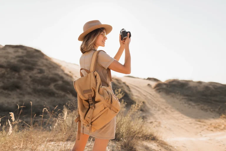 attractive stylish young woman khaki dress desert traveling africa safari wearing hat backpack taking photo vintage camera 285396 9174