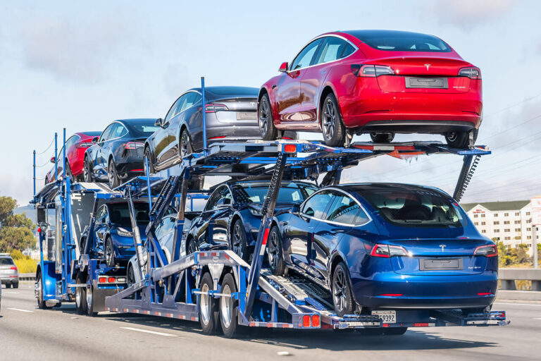 cars being shipped on transporter flatbed truck