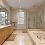homeguide white rectangular floor tiles installed in bathroom with walk in shower with tile surround