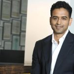 Man in suit smiling in office