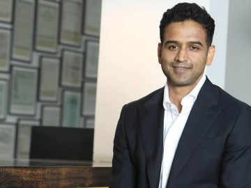 Man in suit smiling in office