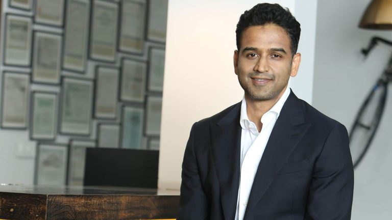 Man in suit smiling in office