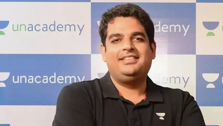 Person in front of Unacademy banner