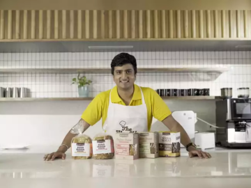 Man displaying bakery products on counter